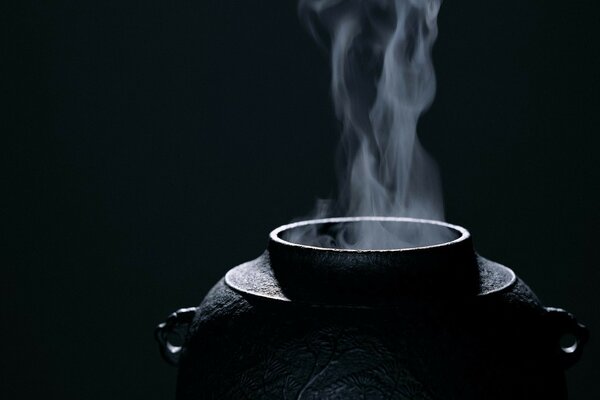 A vat with steam on a black background