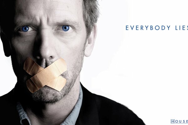 Portrait of Hugh Laurie with his mouth taped shut