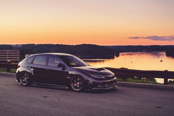 Subaru by the river at sunset