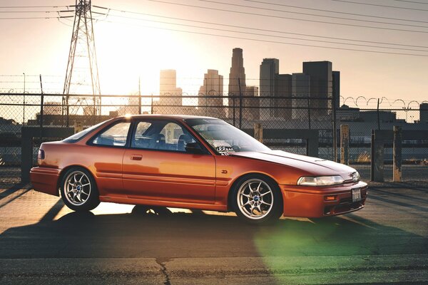 Car on the background of the city. The car is at sunset. The car is a beautiful photo