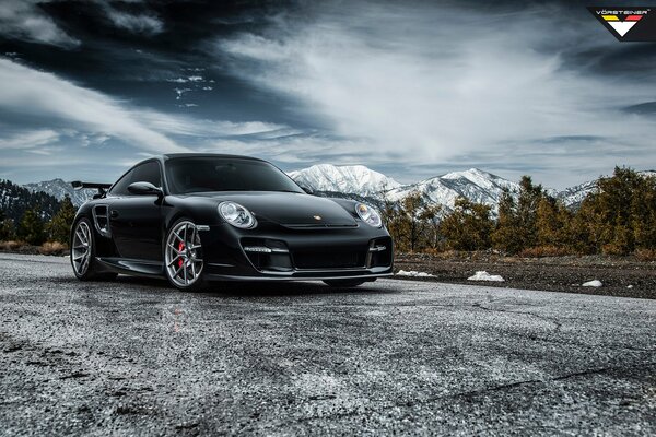 Black Porsche 911 tuning on the background of mountains