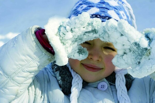 Invierno. Niño. Mitones en la nieve