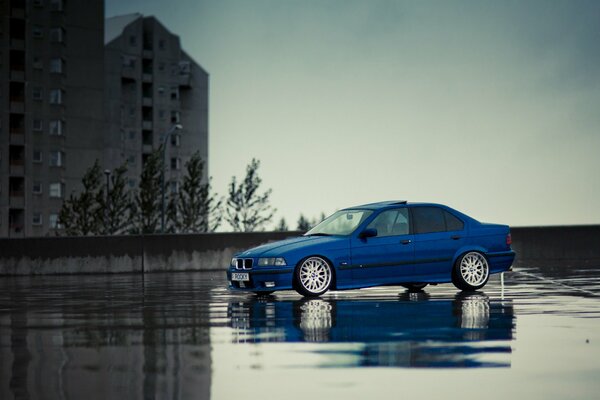 Blue BMW m3 e36 car on wet asphalt