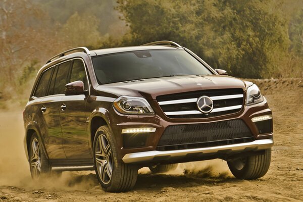 Brown mercedes-benz station wagon rides off-road