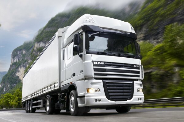 A huge DAF truck at high speed on a mountain road