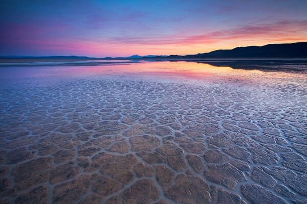 Clear water in the desert at sunset