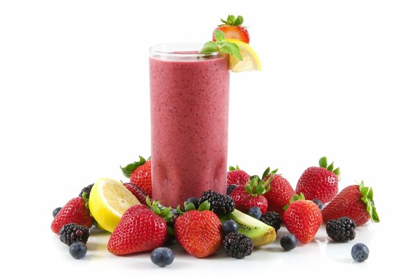 A glass of berry cocktail on a white background with berries