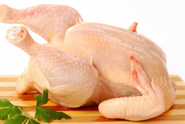 Carcass of fresh chicken on a cutting board