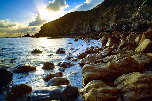 The stone shore illuminated by the bright sun