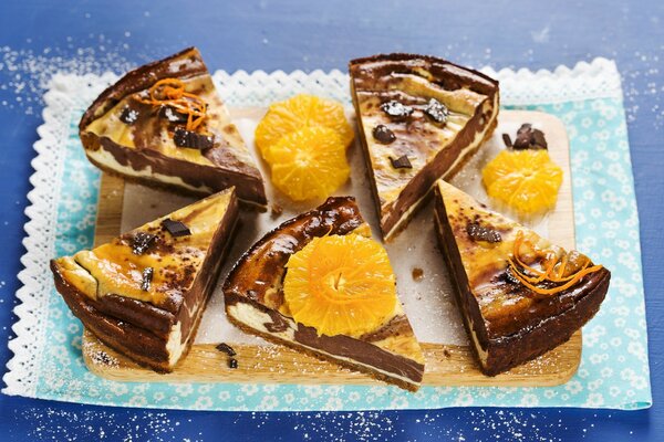 Cinq tranches de cheesecake au chocolat avec des tranches d orange