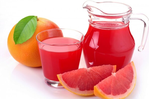 Grapefruit and a jug with a glass of juice