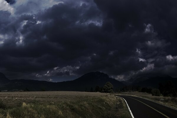 Nubes que se avecinan en el camino de la tierra montañas