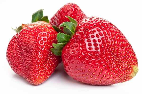 Three red strawberries on a white background