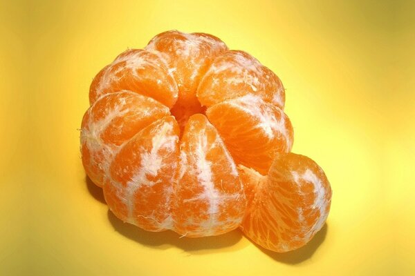 Large peeled tangerine with a slice