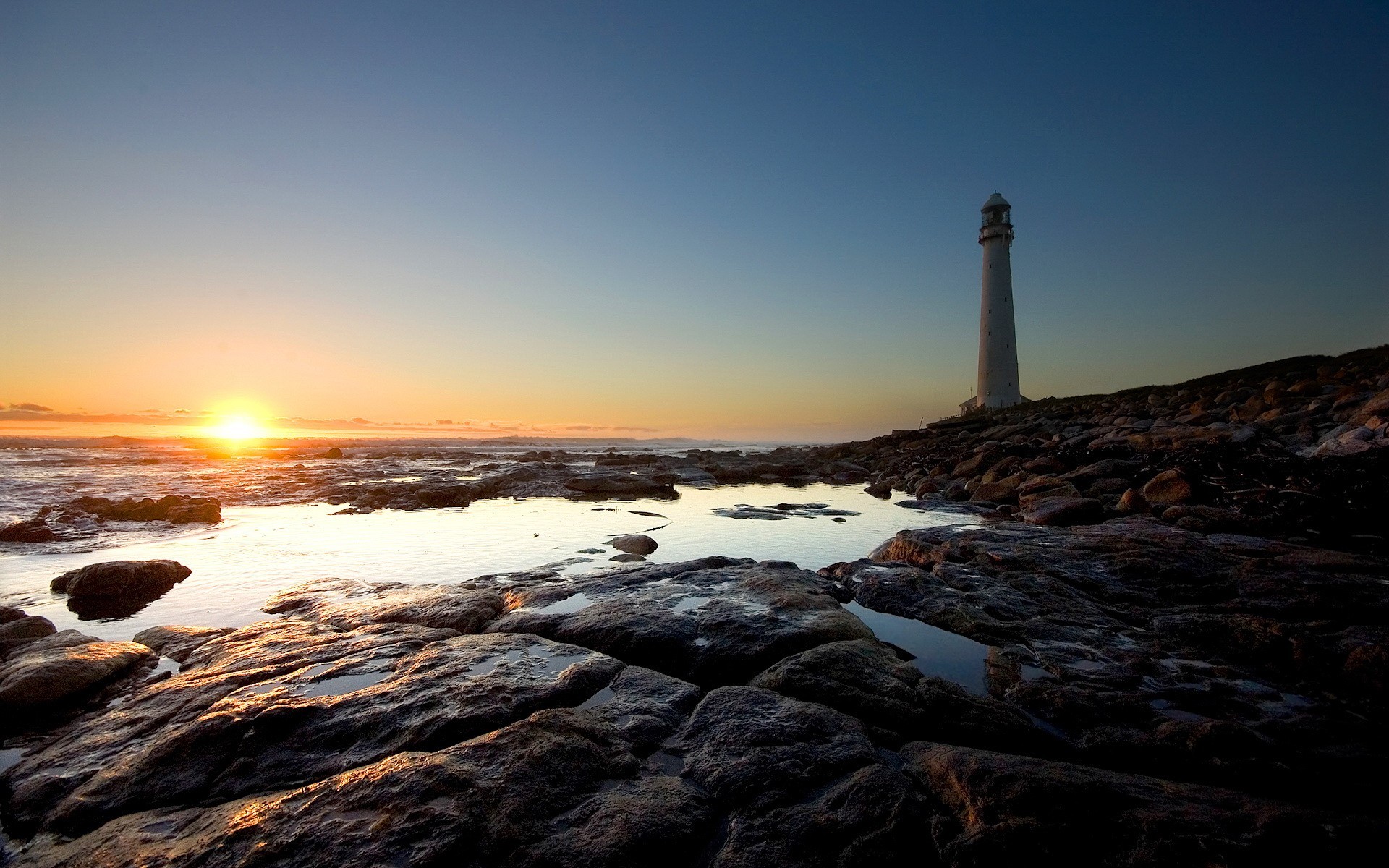 lighthouse sun stones beach