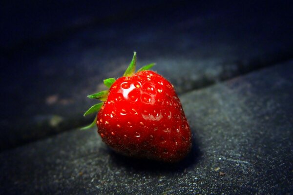 Ripe sweet strawberries on a dark background