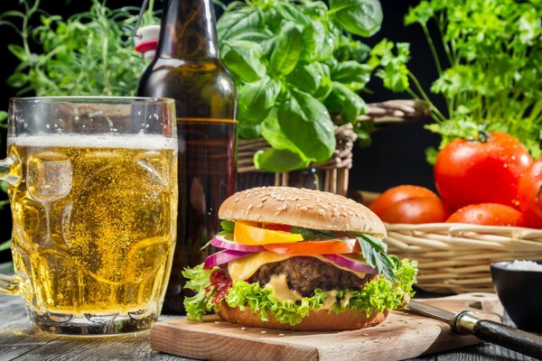 Juicy burger with a beer mug