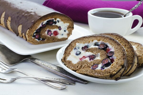 Chocolate roll with berries and a mug of tea