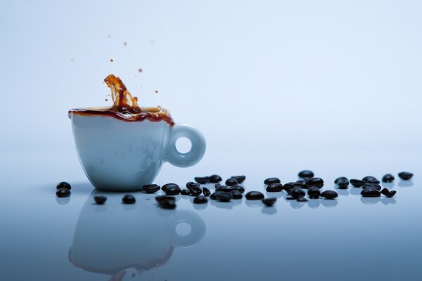 A glass of coffee and black beans on the table