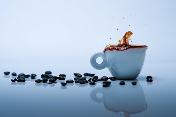 Reflection of a cup of coffee and beans