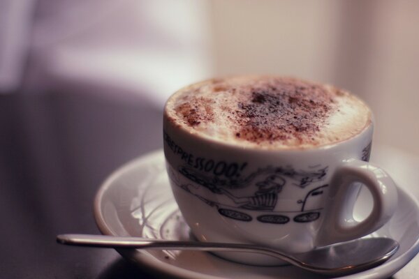 A saucer and a cup of coffee on a light background