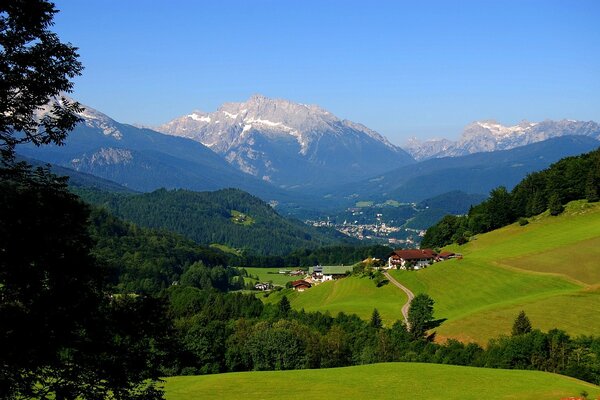 Rustic landscape. Mountains and green meadows