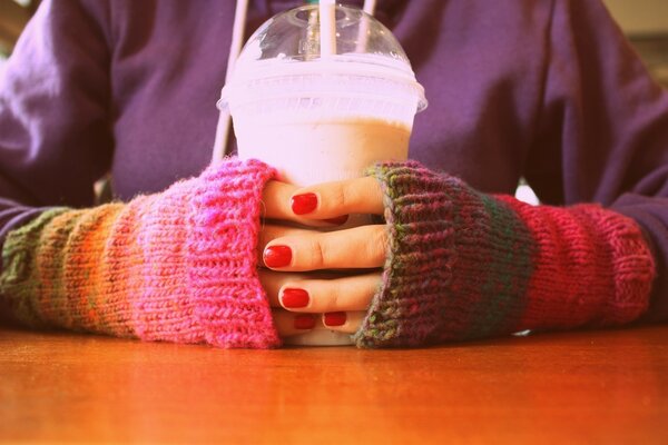 Yogurt in the hands with a red manicure