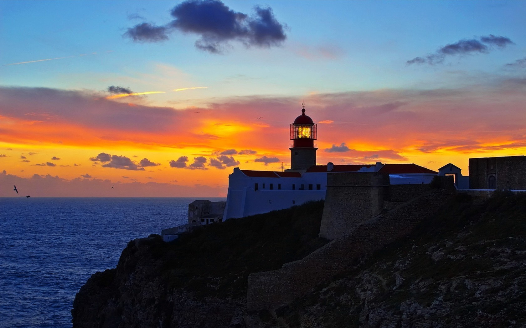 faro puesta de sol nubes