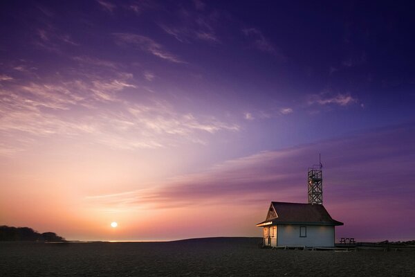 Haus am Meer, vor dem Hintergrund von Himmel und Sonne