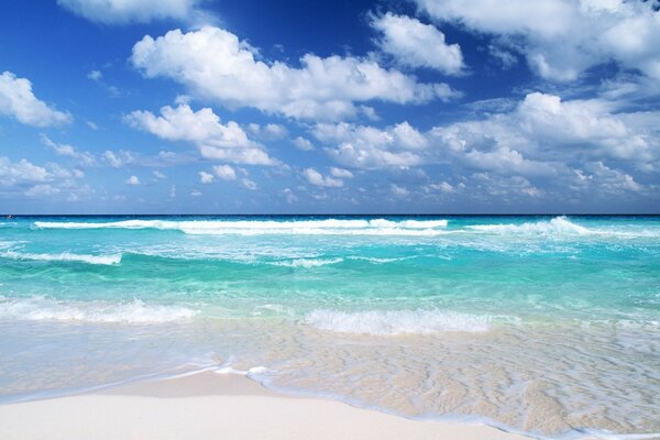 Azurblaue Wellen und weißer Sand
