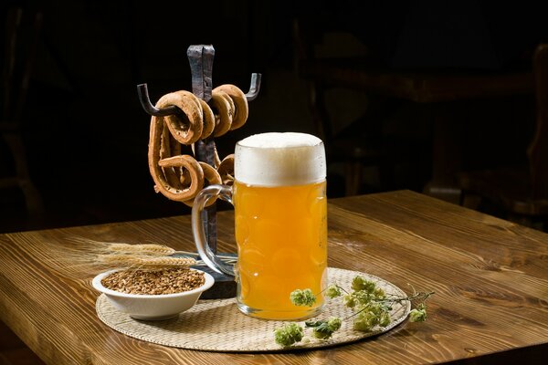 A mug of unfiltered beer with pretzels