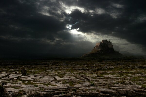 A gloomy castle in the desert in the clouds