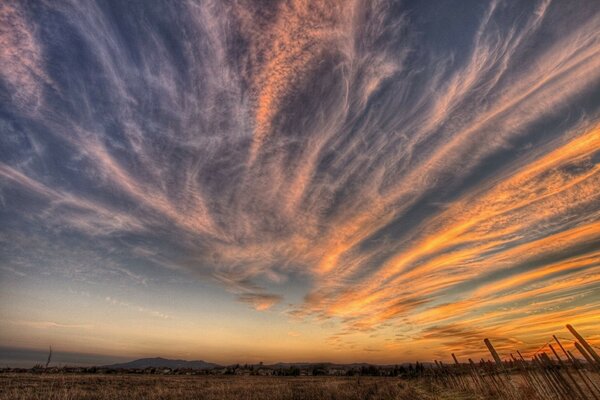 Sunset with air clouds on the field