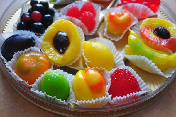 A dish with bright sweets in the form of fruits