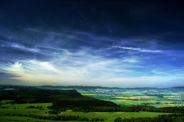 Bright sky over a green plain