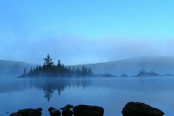 Foggy lake, view of the lake in the fog, foggy island