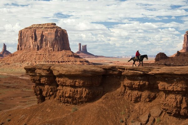 Cowboy on a mountain trail