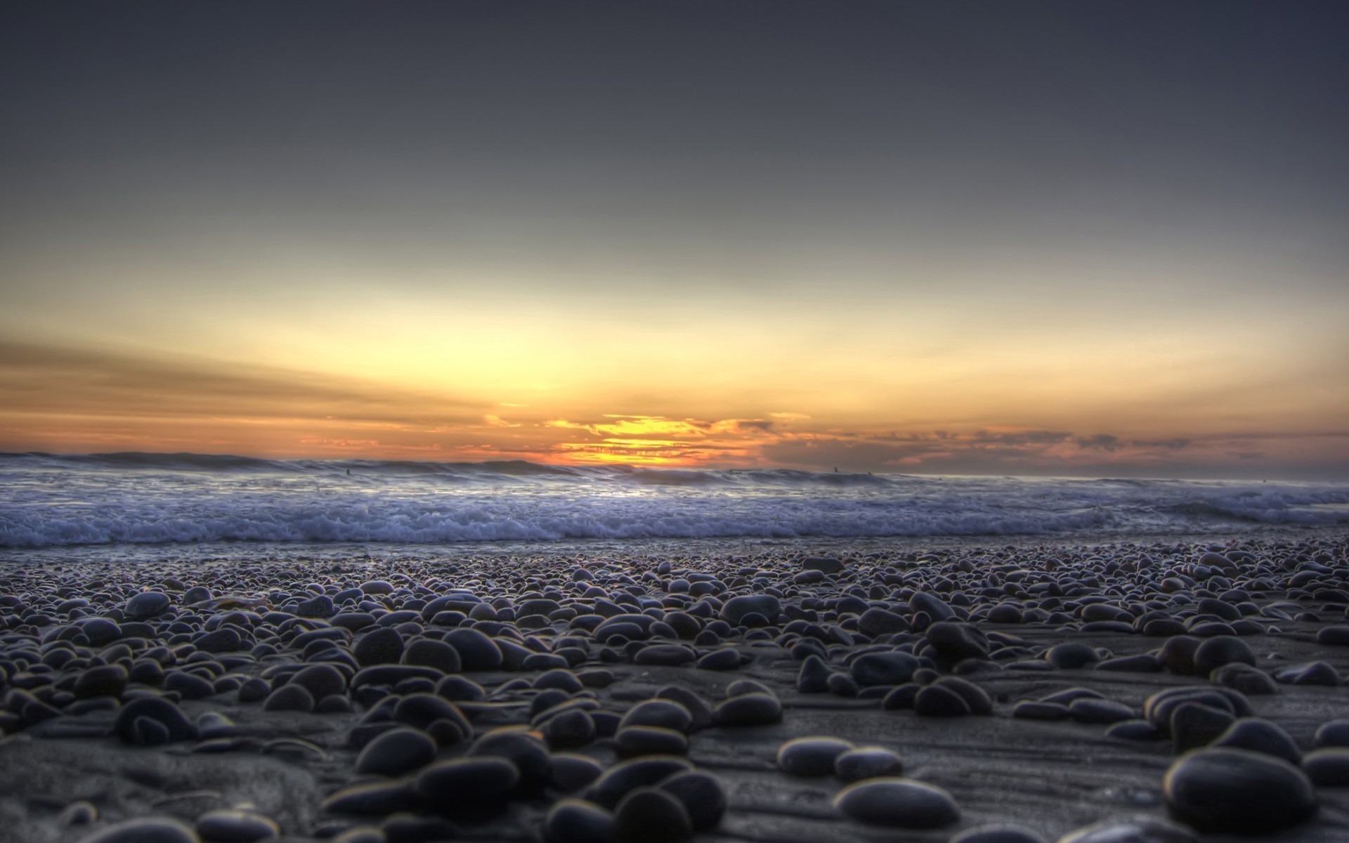 tones pebbles beach sea waves sunset