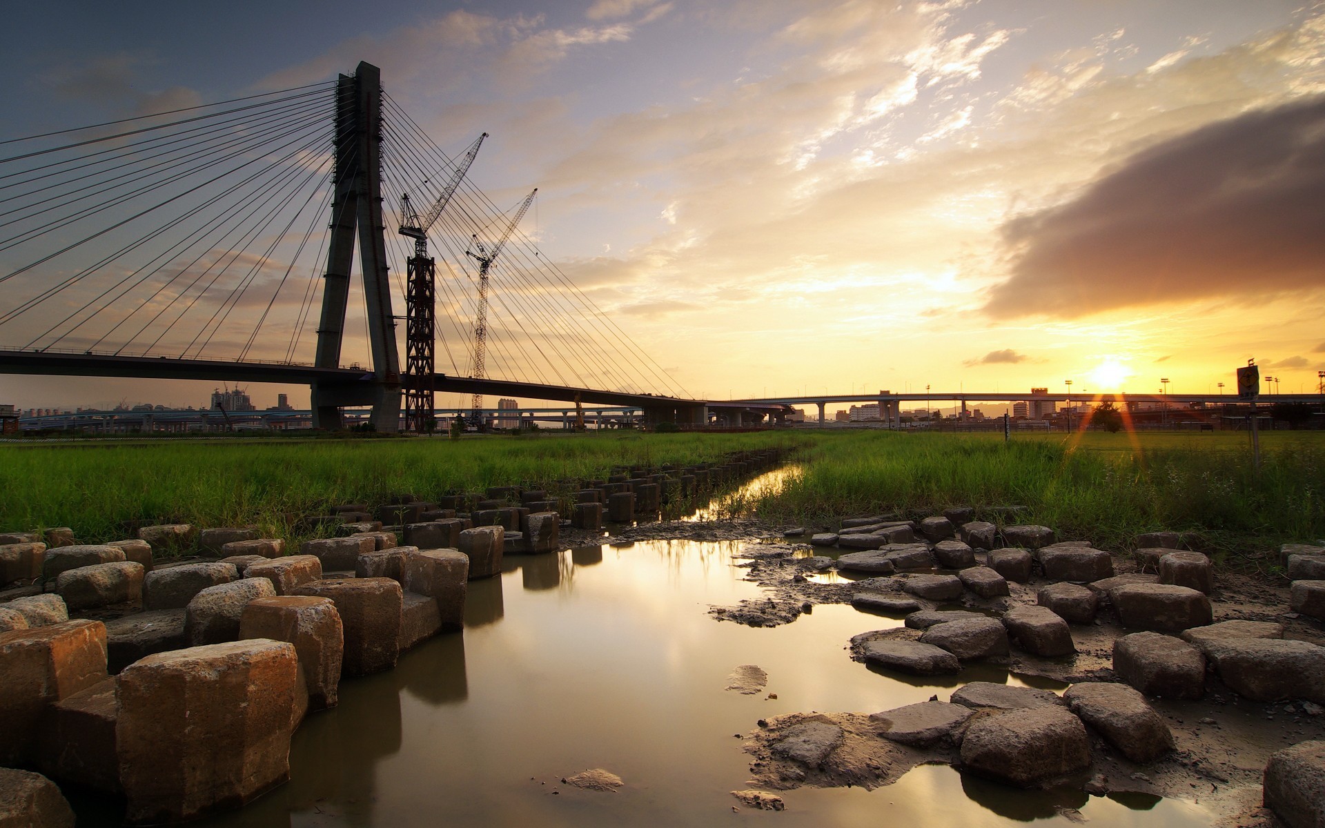 bridge construction sunset stones water