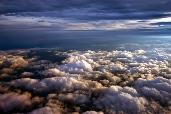 Voler au-dessus des nuages dans le ciel plein de lumière