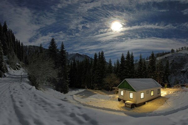 A house in the night, winter forest