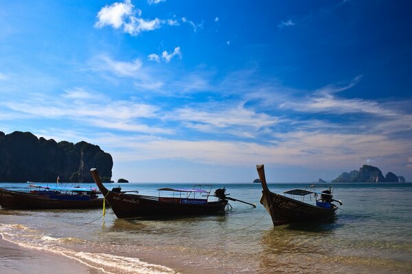 Surf, sea, beach, three canoes