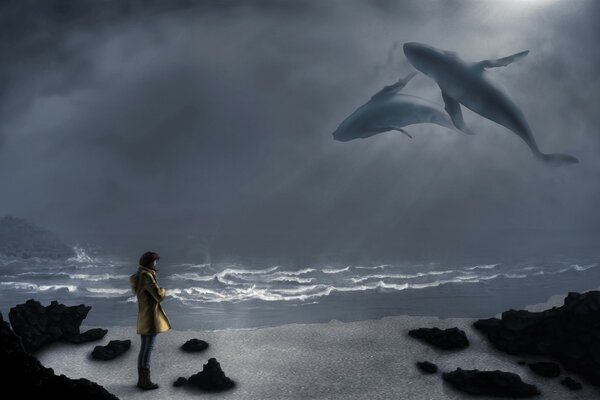 Image avec des baleines dans le ciel. Homme solitaire sur le rivage