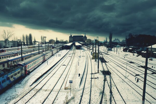 A large railway station with trains in winter