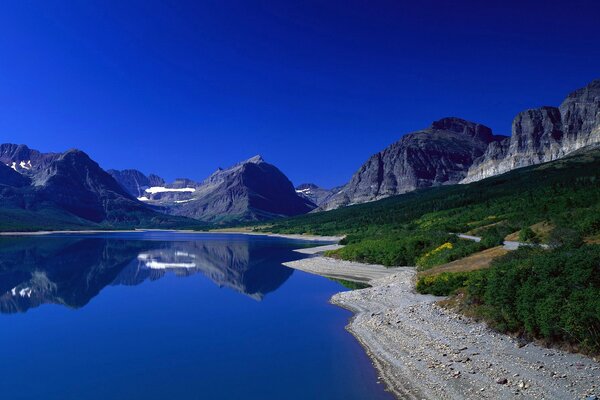 Reflection of mountains in water and greenery