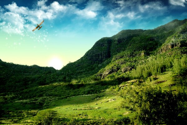 A cornhusker in the sky hovering over mountains and forests