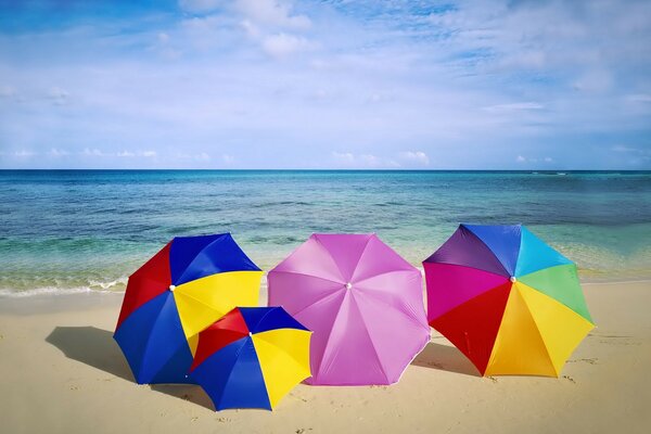 Umbrellas from the sun are bright on the sandy beach at