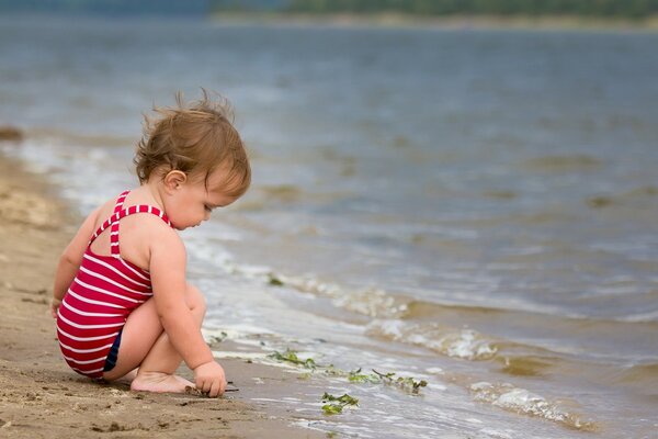 Little girl playing with sand