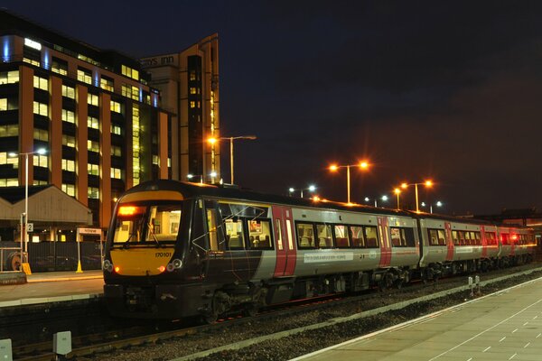 Passenger train on the platform with evening lights