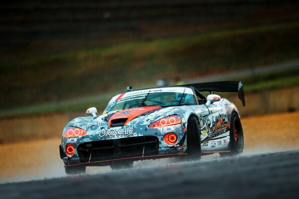Racing car drifts in the rain